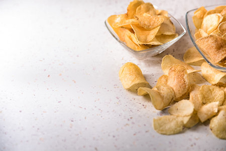 potato chips on a plate on a white background