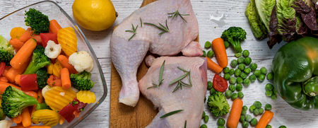 raw chicken legs from vegetables to a wooden table, preparing chicken legs for vegetables, Recipe - ingredientsの写真素材