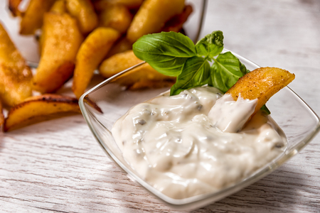 Roasted potatoes with herb sauce in glass dishの写真素材
