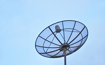 Satellite dish in blue sky の写真素材