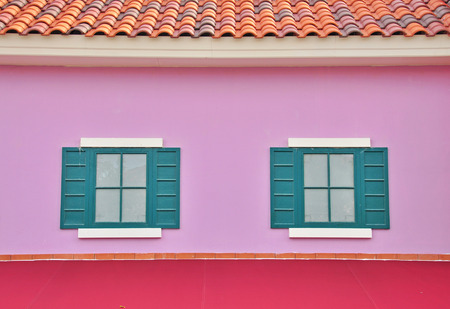 Windows with shutters on violet wall.の写真素材