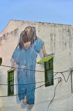 GEORGETOWN PENANG, MALAYSIA - JULY 30, 2015: "Little Girl in Blue" Painted wall mural by artist Ernest Zacharevic in George Town, Penang, Malaysia.のeditorial素材