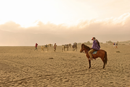 EAST JAVA, INDONESIA - OCT 19, 2015 : Unidentified horse riders for rent to Mount Bromo in East Java, Indonesia. Mt. Bromo is an active volcano and part of the Tengger massif, in East Java.のeditorial素材