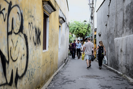 HOI AN, VIETNAM - NOVEMBER 24, 2016: Tourists visit Hoi An ancient town. Hoi An is a popular tourist destination of Asia.のeditorial素材