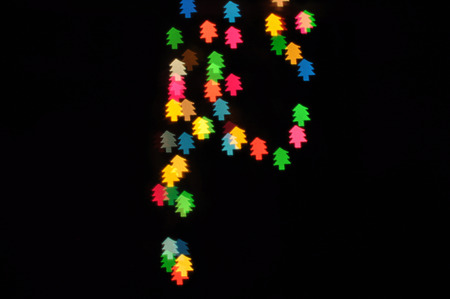 Colorful defocused bokeh lights in blur night background. Christmas trees sign.の写真素材