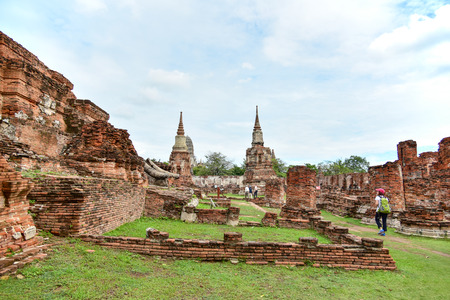 AYUTTHAYA, THAILAND - SEPTEMBER 12 : Unidentified people visit damaged Buddha statues of Wat Mahathat (Temple of the great relics) on September 12, 2015 in Ayutthaya, Thailand.のeditorial素材