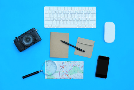 Flat lay of accessories on blue desk background, Voyage concept.の写真素材