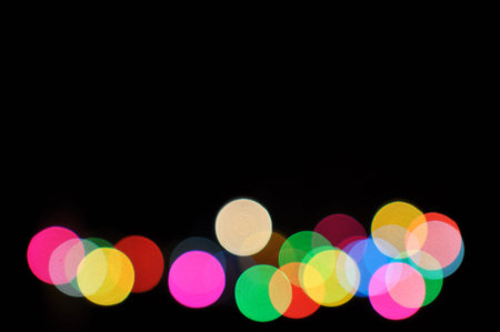 Colorful defocused bokeh lights in blur night background.