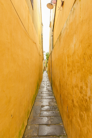 Path between yellow buildings at Hoi An ancient town.の写真素材