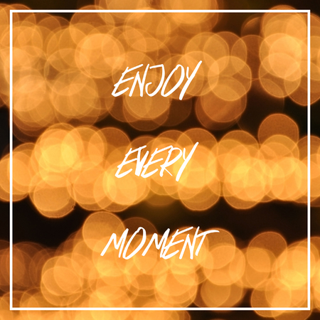 Enjoy every moment text on bokeh lights background.の写真素材