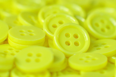 Yellow buttons (clasper) for decoration and background.の写真素材