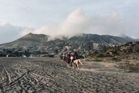 EAST JAVA, INDONESIA - OCT 19, 2015 : Unidentified horse riders for rent to Mount Bromo in East Java, Indonesia. Mt. Bromo is an active volcano and part of the Tengger massif, in East Java.のeditorial素材