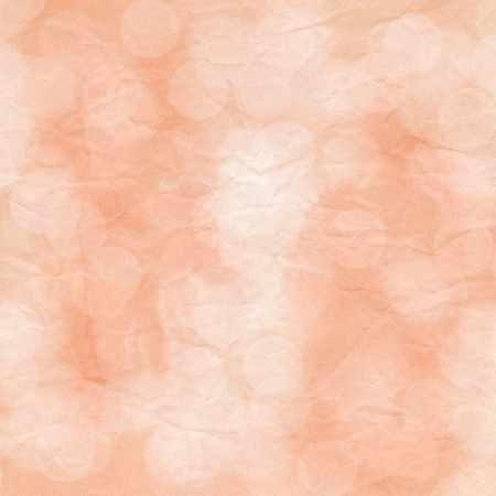 Bokeh light on orange crumpled paper.の写真素材