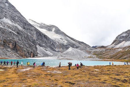 DAOCHENG, SICHUAN , CHINA - OCTOBER 14, 2017 : Unidentified tourists at Milk Lake (Niunai Hai) in Yading national reserve, Daocheng county, Sichuan province, China.のeditorial素材