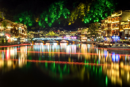 FENGHUANG, HUNAN, CHINA - OCTOBER 06, 2017: The Old Town of Phoenix (Fenghuang Ancient Town) at night. The popular tourist attraction which is located in Fenghuang County, Hunan, China.のeditorial素材