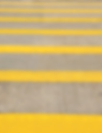 Yellow crosswalk on the road for safety when people walking cross the street. Blurred.