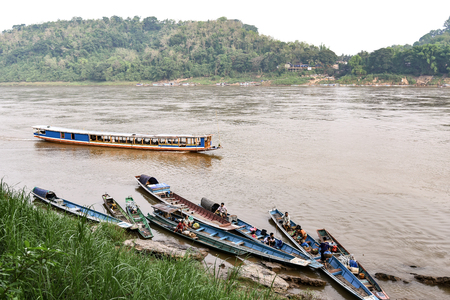 LUANG PRABANG, LAOS - MAY 04, 2015 : Unidentified people on the boat in Mekong river, Luang Prabang, Lao PDR.のeditorial素材