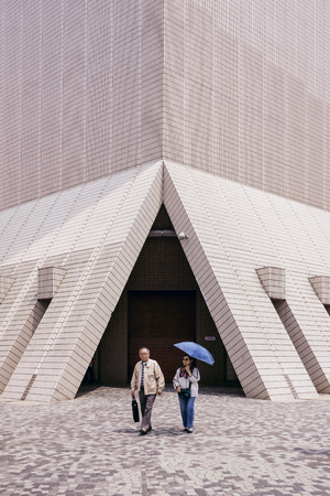 TSIM SHA TSUI, HONG KONG - APRIL 01, 2018 : Senior couple walking at Hong Kong Cultural Centre in Tsim Sha Tsui.のeditorial素材