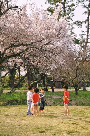 KYOTO, JAPAN - APRIL 08, 2014 : Children playing in the park at Kyoto Imperial Palace in Kyoto.のeditorial素材