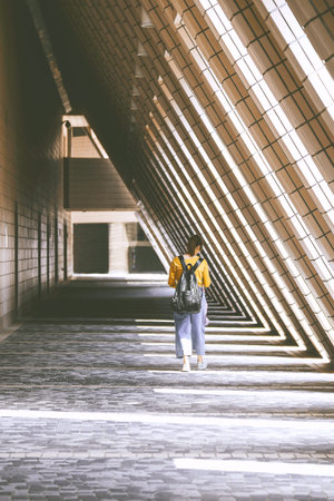TSIM SHA TSUI, HONG KONG - APRIL 01, 2018 : Woman walking at Hong Kong Cultural Centre in Tsim Sha...