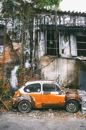 BANGKOK, THAILAND - DECEMBER 26, 2017 : Old orange FIAT 600 car with vintage brick wall at Talad Noi Market in Bangkok, Thailand.のeditorial素材