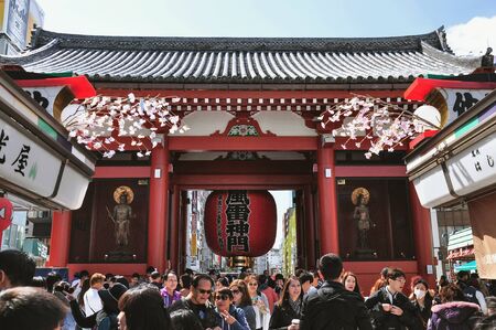 TOKYO, JAPAN - APRIL 05, 2014 : Tourists walk at Nakamise Dori in Sensoji shrine. Nakamise Dori has numerous stores lined up from Kaminarimon Gate to Hozomon Gate at Senso-ji.のeditorial素材
