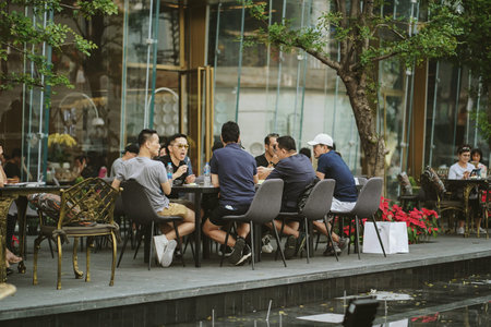 BANGKOK, THAILAND - DECEMBER 23, 2018 : Tourists sitting in front of ICONSIAM department store in...