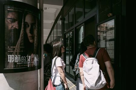 YAU MA TEI, HONG KONG - MARCH 31, 2018 : Unidentified people are reading advertisement at a news board of Broadway Cinematheque in Yau Ma Tei District, Hong Kong.のeditorial素材