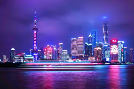 SHANGHAI, CHINA - MAY 18, 2019: Cityscape of Shanghai and Huangpu river at night in Shanghai, China. Pink and blue neon lights.のeditorial素材