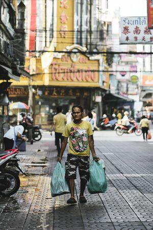 BANGKOK, THAILAND - OCTOBER 15, 2018 : Unidentified man walking at Yaowarat(Chinatown) in Bangkok, Thailand.のeditorial素材