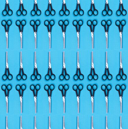 Seamless pattern of hairdressing scissors on blue background.の写真素材