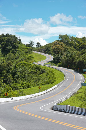 Road on Root 1081 among the mountains between Santi Suk and Bo Kluea districts of the Nan Province, Thailand.の写真素材