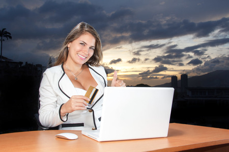 Beautiful woman using her credit card on the web shopping onlineの写真素材
