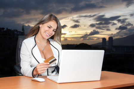 Beautiful business young woman shopping online with credit cardの写真素材