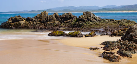The beautiful wet sand and rocks covered in algae. Playa Mayto in Jalisco, Mexico.