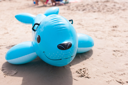 inflatable toy fish on beachの写真素材