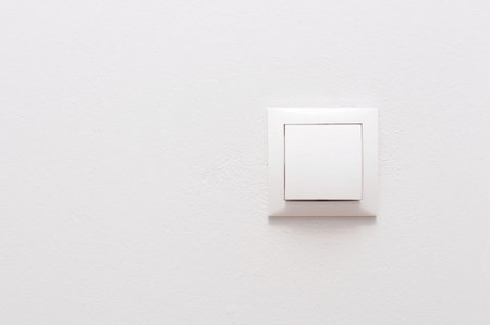 White light switch on a white wall