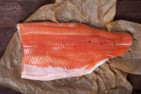 Raw salmon fillet on kitchen paperの写真素材