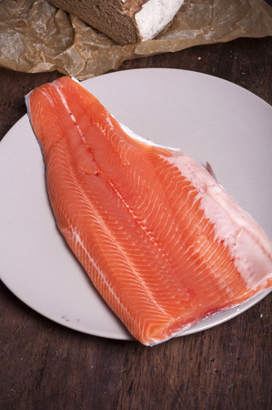 Raw salmon fillet on kitchen paperの写真素材