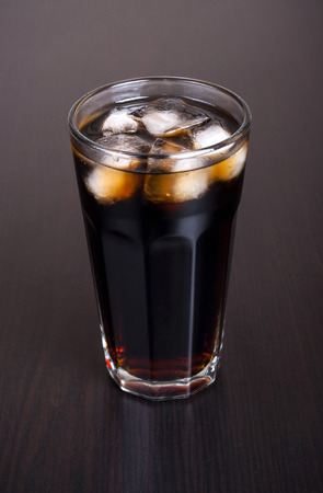 Black cola in a glass with ice real, not plasticの写真素材