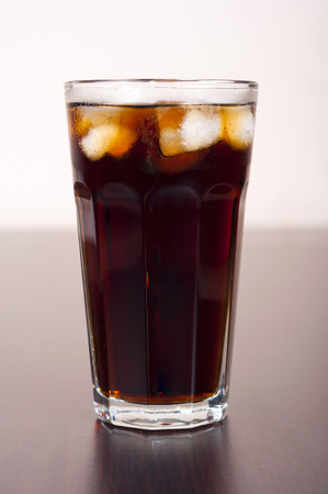 Black cola in a glass with ice real, not plasticの写真素材