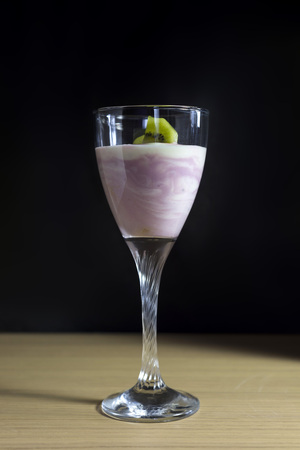 Homemade yogurt with kiwi fruit, pears and berries in a glassの写真素材