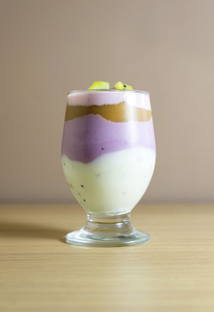 Homemade yogurt with kiwi fruit, pears and berries in a glassの写真素材