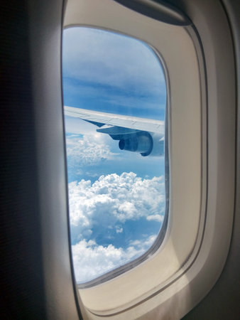 Clouds and sky as seen through the window of an aircraft