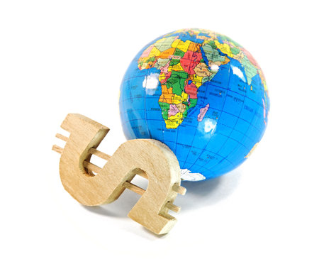 The wooden sign on dollar and the globe are isolated on a white backgroundの写真素材