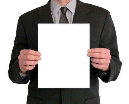 Image of a businessman's torso. He is holding a blank sheet of paper in front of him. の写真素材