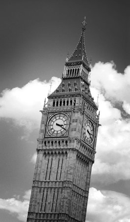 Black and white image of Big Ben clock tower in London, England, against dramatic clouds. Image has...