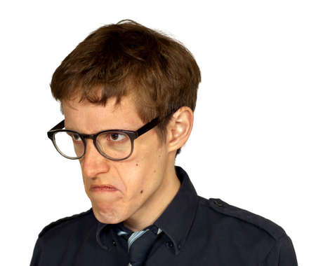 Quarter view of man in black shirt and tie with glasses looking displeased, isolated on white background の写真素材
