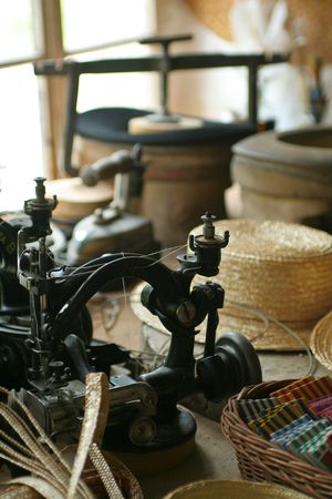 Old-fashioned hat-making shop with old-time sewing machine.の写真素材