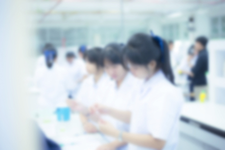 Young laboratory assistant prepare instrument for chemical lab experiment in Lab,blur image of old laboratory for background usage.の写真素材